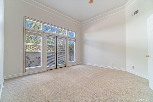 unfurnished room featuring ceiling fan, light colored carpet, and crown molding