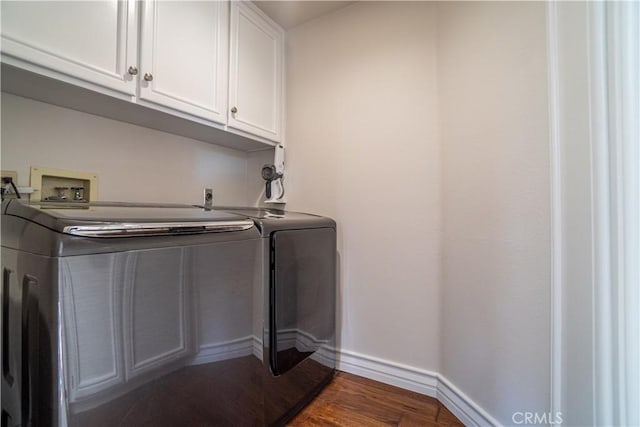 laundry area featuring dark hardwood / wood-style flooring, cabinets, and independent washer and dryer