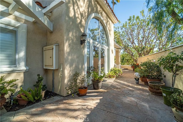 view of home's exterior with a pergola and a patio