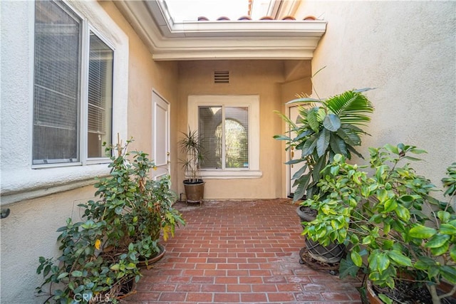 entrance to property featuring a patio