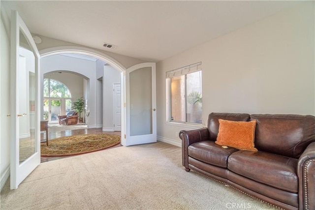 living room with french doors and carpet