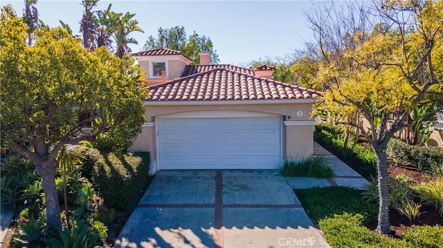 mediterranean / spanish-style house with a garage