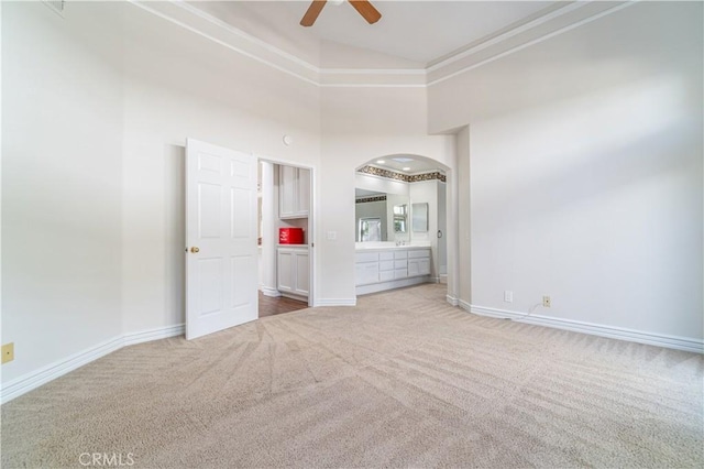 carpeted spare room with high vaulted ceiling and ceiling fan