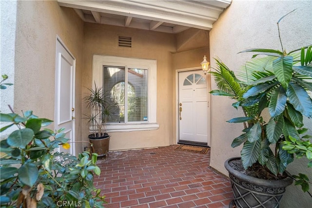 doorway to property with a patio area