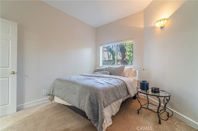 bedroom featuring vaulted ceiling and carpet