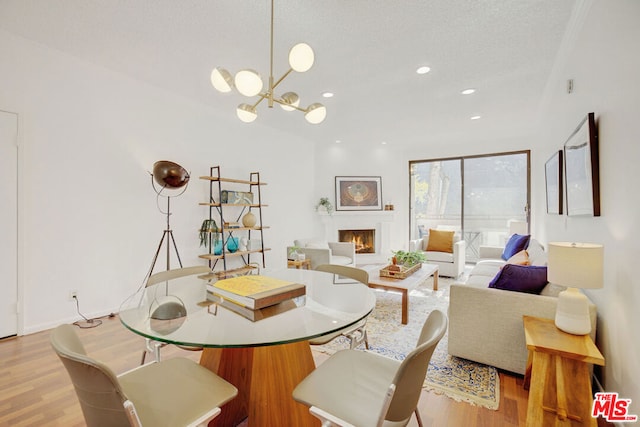 dining area featuring light hardwood / wood-style flooring and an inviting chandelier