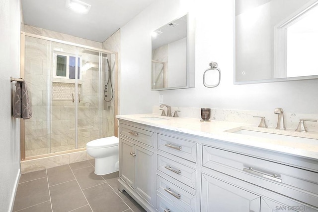 bathroom with toilet, tile patterned flooring, walk in shower, and vanity