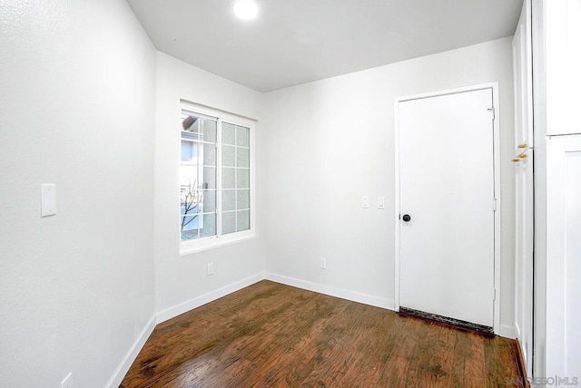 unfurnished room featuring dark hardwood / wood-style flooring