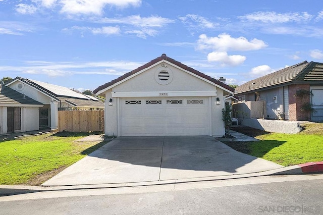 single story home featuring a front lawn and a garage