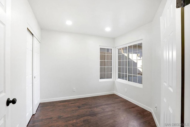 spare room featuring dark hardwood / wood-style flooring