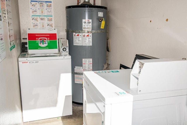 utility room with gas water heater and washing machine and dryer