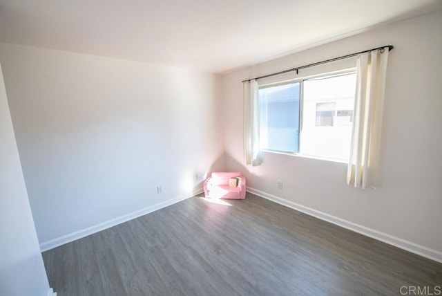 spare room with dark wood-type flooring