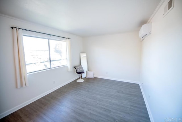 spare room featuring dark wood-type flooring, ornamental molding, and a wall mounted AC