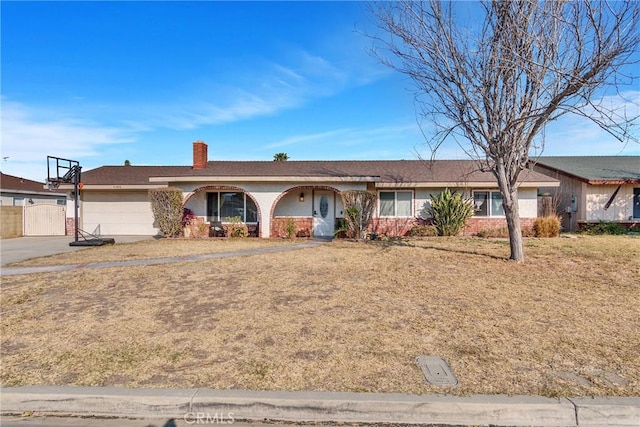 ranch-style home featuring a garage and a front yard