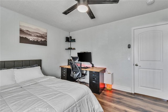 bedroom featuring ceiling fan and dark wood-type flooring