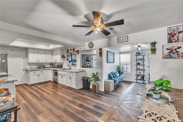 kitchen featuring white cabinets, dark hardwood / wood-style floors, and a textured ceiling