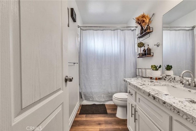 full bathroom with vanity, hardwood / wood-style flooring, toilet, and shower / bathtub combination with curtain