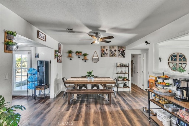 dining room with a textured ceiling, dark hardwood / wood-style flooring, and ceiling fan