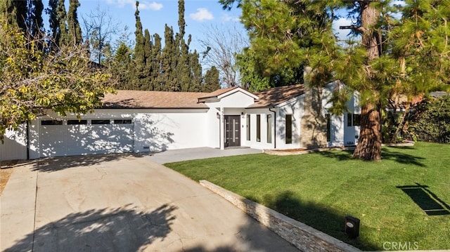 ranch-style home featuring a front yard and a garage