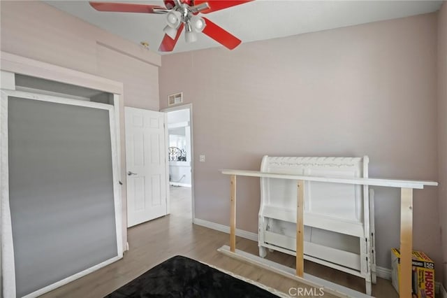 unfurnished bedroom with ceiling fan and wood-type flooring