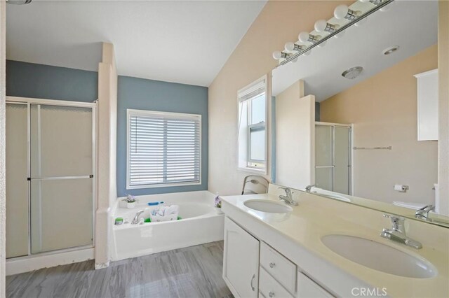 bathroom featuring lofted ceiling, separate shower and tub, and vanity