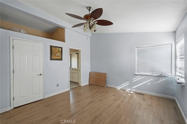 unfurnished room featuring ceiling fan, vaulted ceiling, and light hardwood / wood-style floors