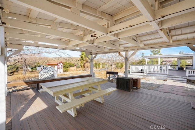 wooden deck with a storage shed