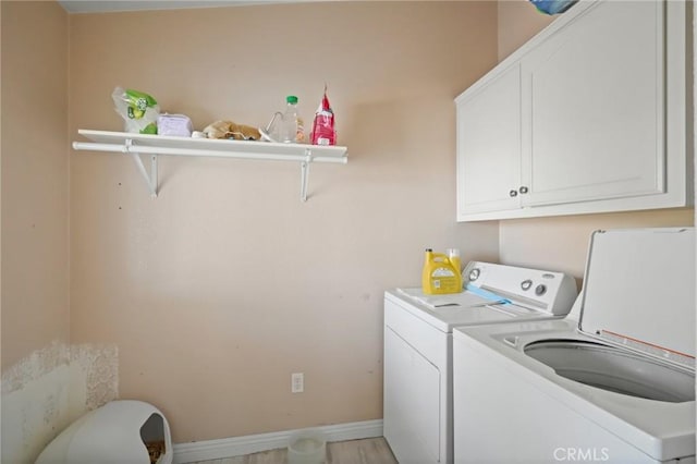 laundry room featuring cabinets and washing machine and clothes dryer