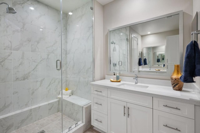 bathroom featuring an enclosed shower and vanity