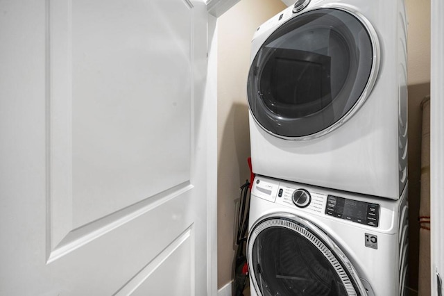 laundry area featuring stacked washer and clothes dryer