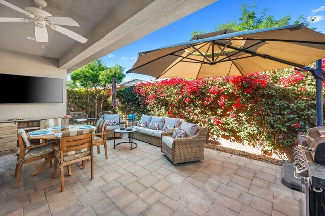 view of patio / terrace with ceiling fan and an outdoor living space