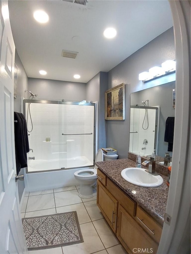 full bath with tile patterned floors, bath / shower combo with glass door, toilet, visible vents, and vanity