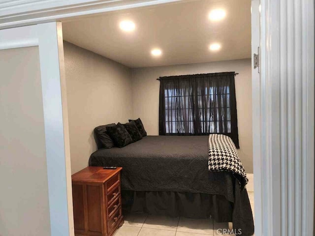 tiled bedroom featuring recessed lighting
