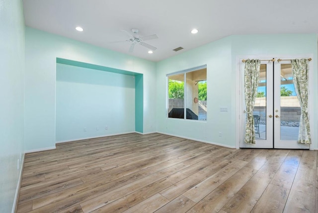 unfurnished room with light hardwood / wood-style floors, ceiling fan, a wealth of natural light, and french doors