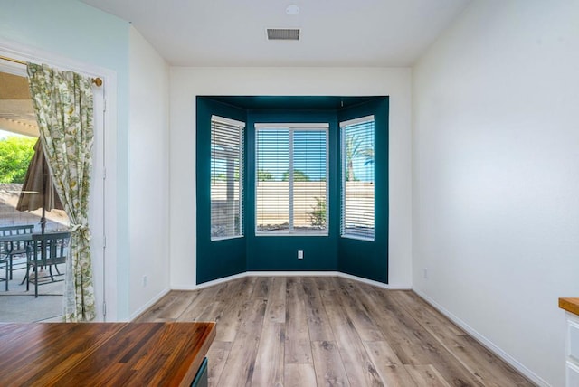 spare room featuring light hardwood / wood-style floors