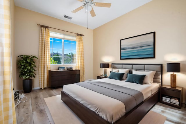 bedroom with light wood-type flooring and ceiling fan