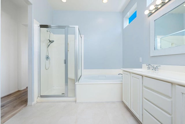 bathroom featuring vanity and shower with separate bathtub