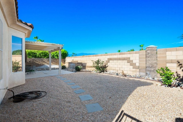 view of yard with a pergola and a patio