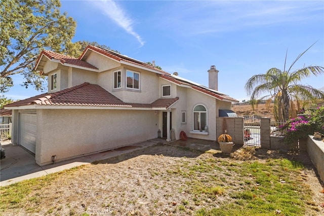 rear view of house with a garage