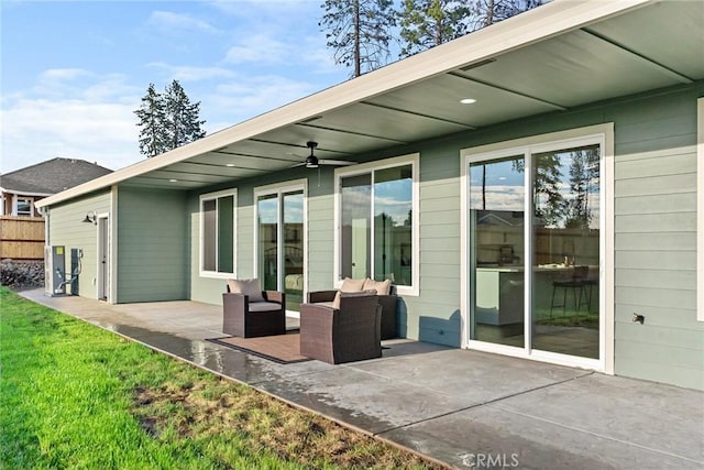 rear view of house with ceiling fan, outdoor lounge area, a lawn, and a patio