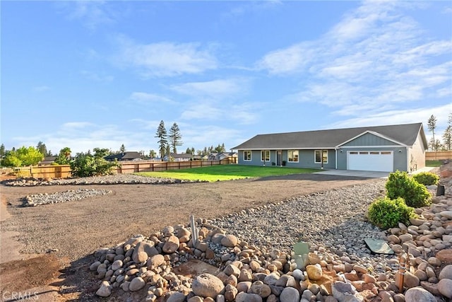 ranch-style home with a front lawn and a garage