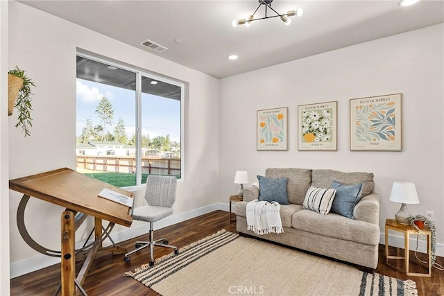 living area with a chandelier and hardwood / wood-style flooring