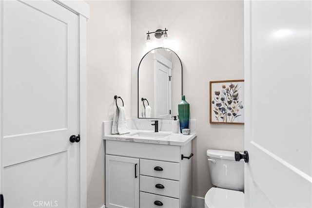 bathroom with toilet and vanity