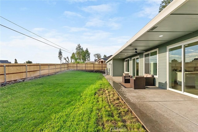 view of yard with an outdoor living space and a patio