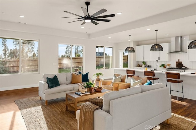 sunroom / solarium featuring ceiling fan and sink