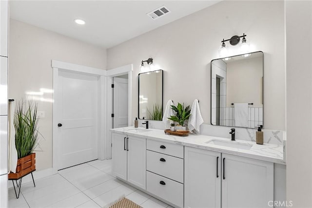 bathroom featuring tile patterned flooring and vanity