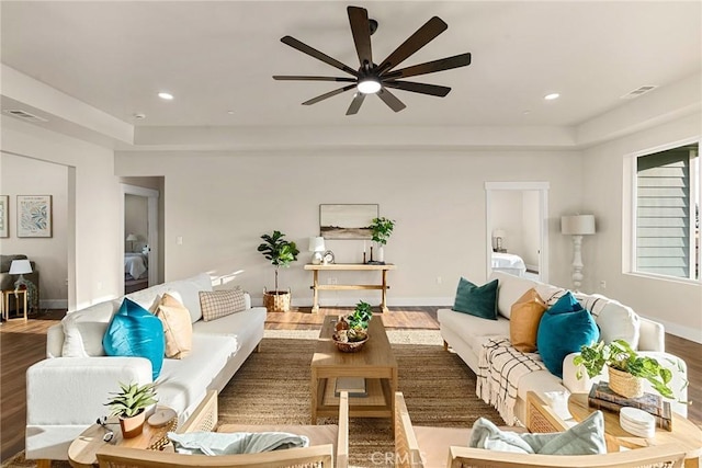 living room featuring ceiling fan and wood-type flooring