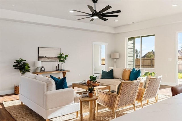 living room featuring ceiling fan and hardwood / wood-style flooring