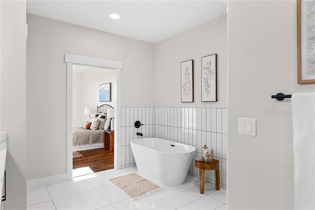 bathroom featuring tile patterned floors and a bath