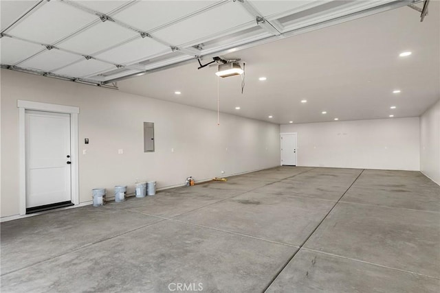 garage with a garage door opener and electric panel